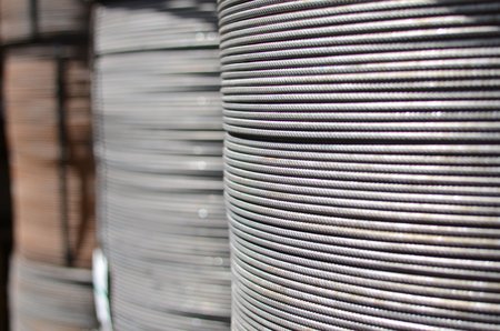 Große Rollen aus dicht gewickeltem Stahlseil bzw. Draht, Nahaufnahme mit unscharfem Hintergrund.
